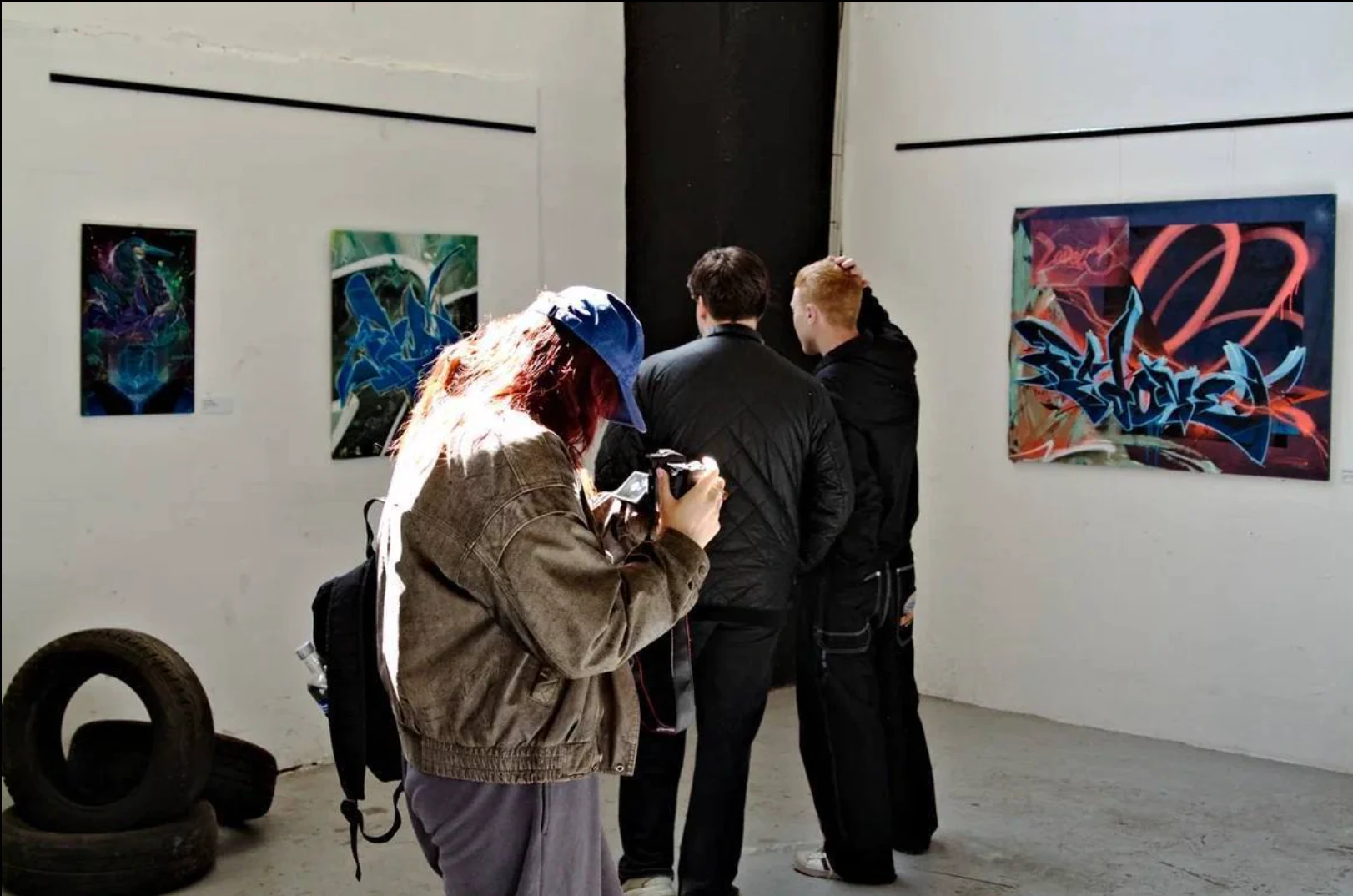 Visitors viewing artworks at the B-Walls 2025 exhibition